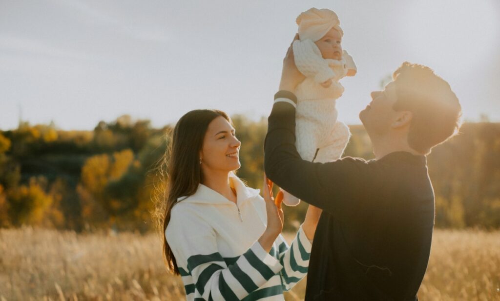 Man and Women Playing with Infant Child